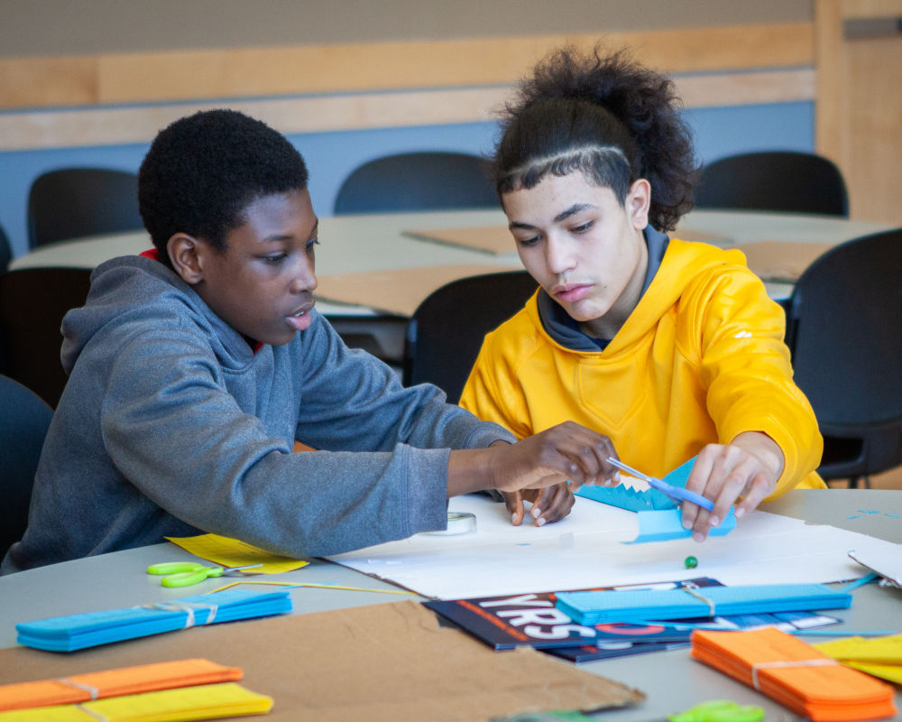 two engineering your future male students doing a project together