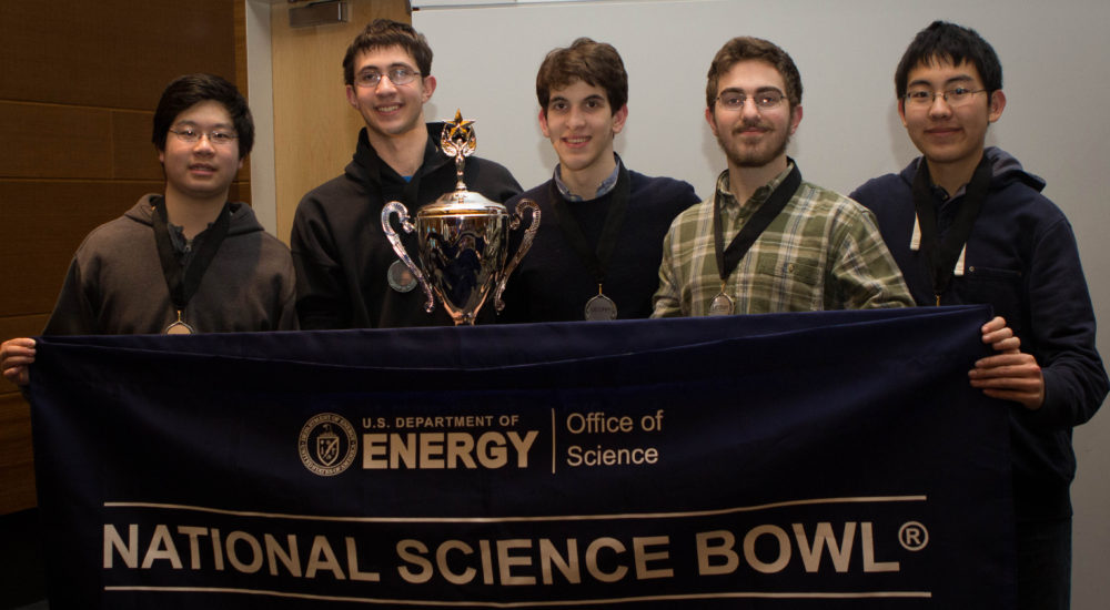 five male students with their trophy and national science bowl banner