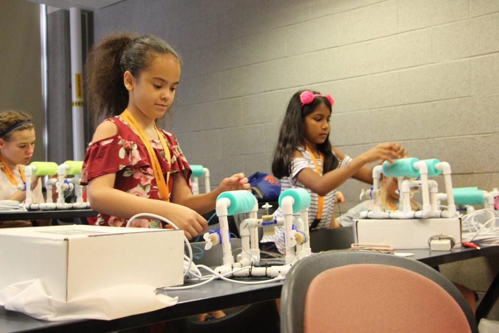 young female students conducting lab work for SPARK