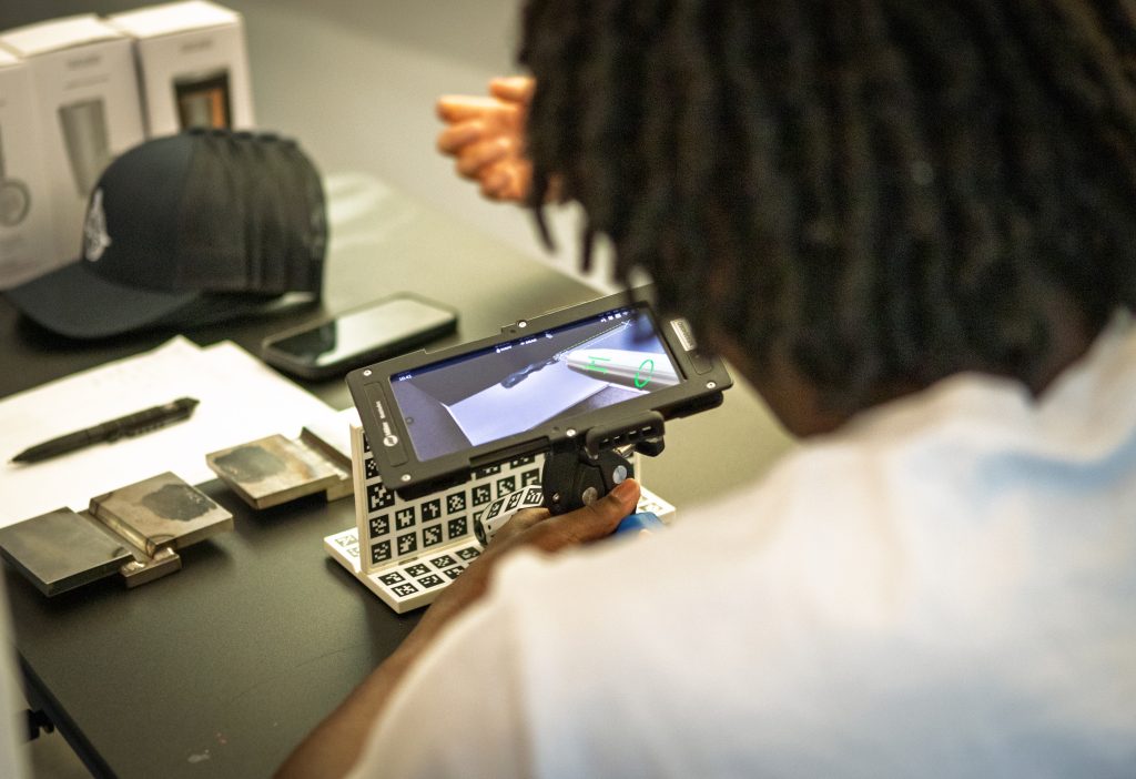 A student using a technological device on Explore Engineering Day.