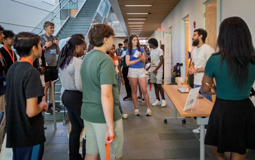 A group of students talking in the lobby of the McHugh building on Explore Engineering Day.