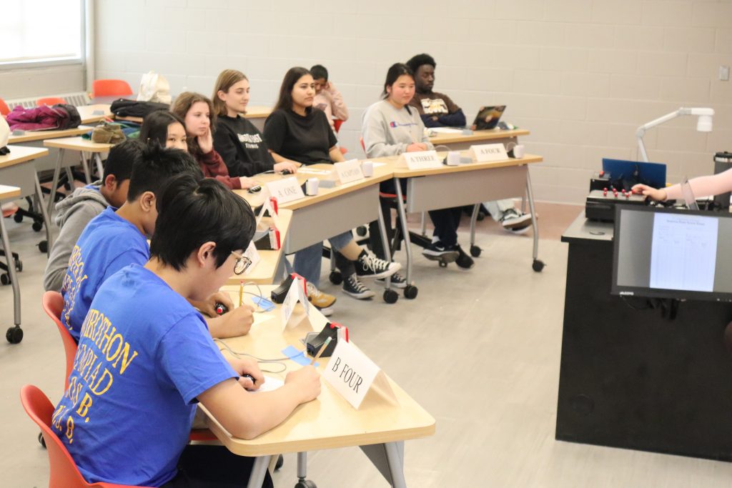 Two teams of students playing in a Science Bowl tournament round.