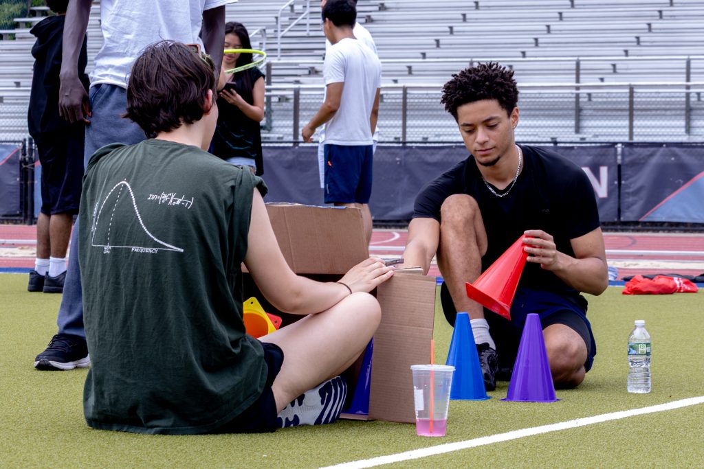 Two students completing a cone-matching activity as part of a BRIDGE field day challenge.