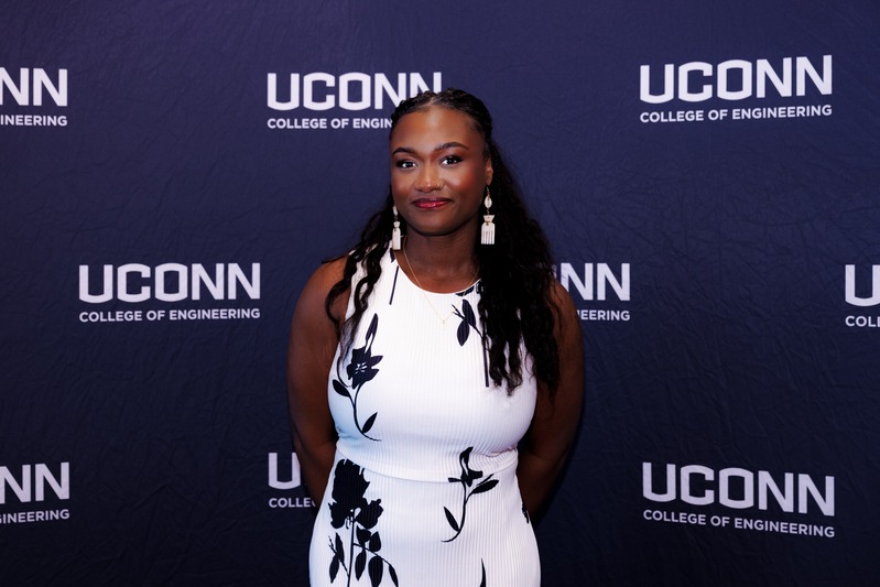 A professional headshot photo of Durga Nyame taken in front of a blue and white background with the UConn College of Engineering logo.